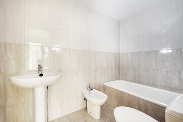 Naklejka na ściany i meble A bathroom with a simple design with its four white porcelain toilets