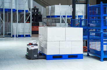 warehouse robot car carries cardboard box assembly in factory