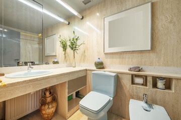 Bathroom with quality marble furniture and tiling with blue porcelain sink and wall-to-wall mirror...