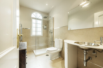 Bathroom with designer furniture in white wood, frameless mirror and square shower cabin with glass partition and white aluminum window
