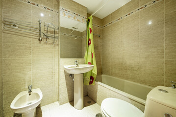 bathroom with bathtub, rectangular mirror attached to the wall and green curtains in the shower