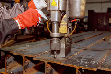 Portable magnetic drill. Portable mag drill makes deep holes in solid steel or plates.