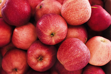 Crate of fresh ripe harvested red apples from market, selective focus, shallow DOF
