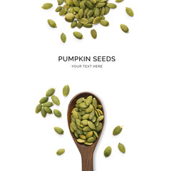 Creative layout made of pumpkin seeds and wood spoon on a white background. Top view.  