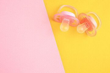 New baby pacifiers on color background, flat lay. Space for text