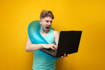 guy in the summer on vacation with an inflatable swim ring holding a laptop and screaming, angry...