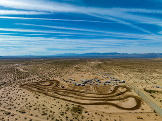 Panoramic overhead view of dirt motorcycle track in barren desert landscape in the Mojave desert