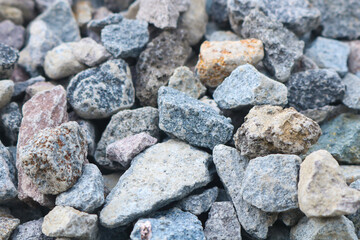 Gravel texture. Pebble stone background. Light grey closeup small rocks.
