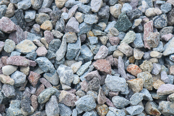 Gravel texture. Pebble stone background. Light grey closeup small rocks.