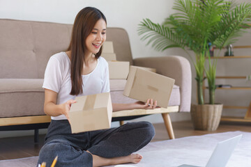 Online selling concept, Asian business woman talking on video call to showing parcel box for client