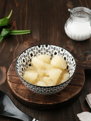 Singkong thailand, sweet cassava, made of boiled cassava, sugar and coconut milk. Served in bowl with pandan leaf
