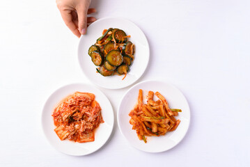 Kimchi cabbage, radish and cucumber  on white background, Korean food homemade side dish, Top view