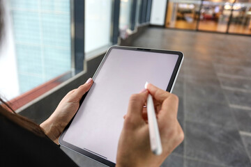 Financial analyst buys shares in the investment market close-up. Working business man on background check. Working business woman on background check. A woman uses a tablet .