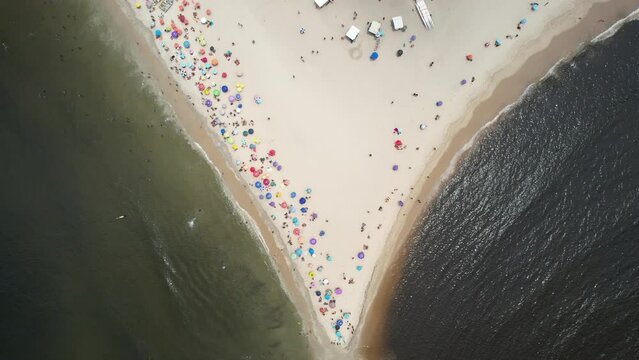 Top down descending altitude view of where Recreio and Sernambetiba beaches meet in Recreio dos Bandeirantes, Rio de Janeiro, Brazil