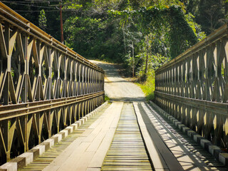 Iron and wooden bridge in rural area.