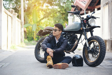 Fototapeta na wymiar Asian man motorbike in black leather jacket travel rider trip. Handsome Men wear sunglass outdoor lifestyle freedom rider. Men trendy hipster cool person. Young asian man hobby ride with motor bike