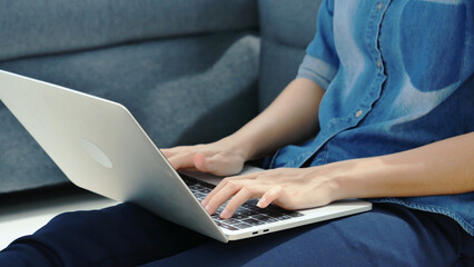 Happiness Asian Woman working from home using laptop online meeting in home office. Happy relax time asian business woman typing keyboard use notebook laptop Smiling, laughing at home office.