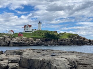 Fototapeta na wymiar scenic lighthouse in Maine with dramatic sky in the background