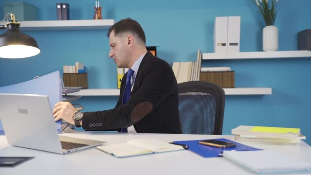 A busy businessman. Hardworking businessman.
The businessman, who is trying to get his work done in the office, gets things done quickly.
