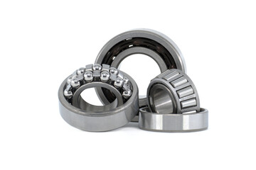Group of various ball and roller bearings on white