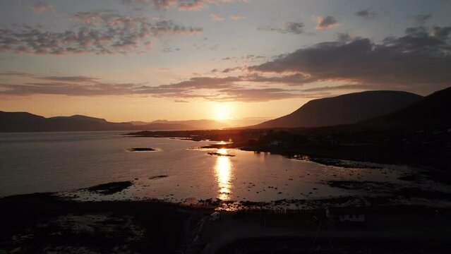 Aerial backwards shot of the stunning Midnight sun in the archipelago of Vester&aring;len in Northern Norway, Sortland