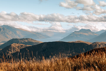 Hiking up Mt Dewar near Queenstown New Zealand at sunset offers perfect views of surrounding mountains and lakes.