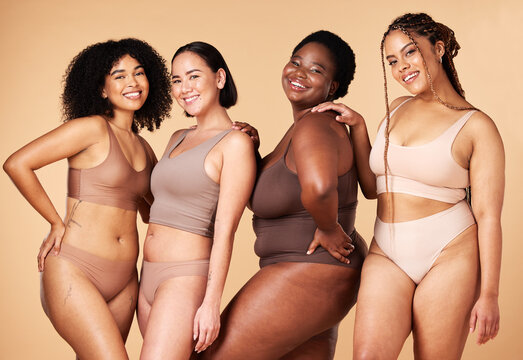 Diversity, happy woman and body portrait of group together for inclusion, skin beauty and power. Underwear model friends on beige background for positivity, pride and motivation support for self love