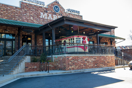 A red brick buildings with a small train in the center at the Marietta Square in Marietta Georgia USA