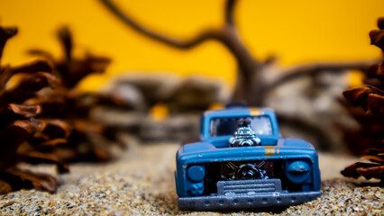 Minahasa, Indonesia : saturday, December 2022, a toy car among the pinecones