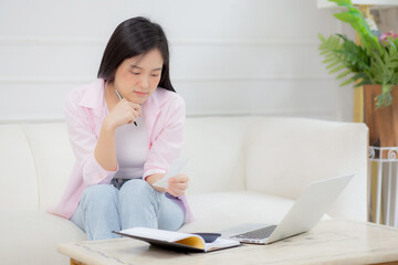 Young asian woman calculating expenses household about finance and frustrated at home, girl checking bill having stress and worried, debt and tax, expression and emotion tired, business concept.