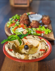 Delicious falafel plate on a wooden table,