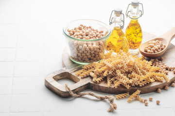 Chickpea bean fusilli pasta on a gray concrete background.