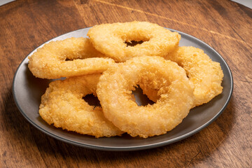 Cheesy Shrimp Doughnut or Shrimp tempura fried donuts on black plate on wooden background. Shrimp Doughnut