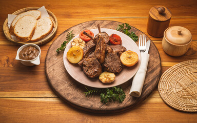 Lamp Rack Steak or Lamb chops Steak with rosemary, onion and tomato on wooden background.