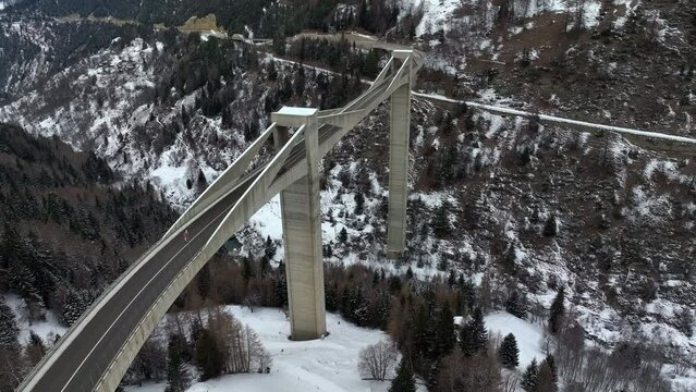 Cars drive over the high modern Ganter Bridge in Switzerland in wintertime. Slowly drone dolley shot