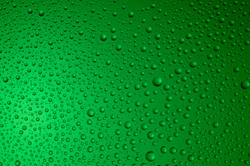 Bubbles and water drops in selective focus on glass, green background. ..