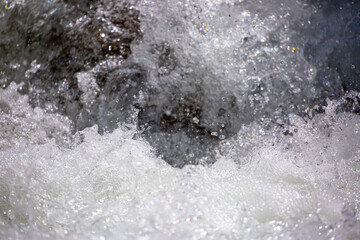 Drops of water, splashing and bubbling waterfall as a background. Foam party or laundry. The concept of freshness of soft drinks.