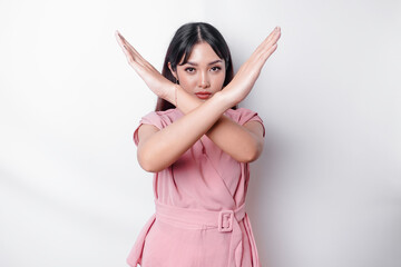 Beautiful Asian woman wearing pink blouse with hand gesture pose rejection or prohibition with copy...