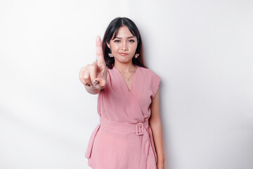 Beautiful Asian woman wearing pink blouse with hand gesture pose rejection or prohibition with copy...
