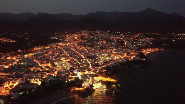 Scenic view from drone of spanish town of Nerja on southern Mediterranean coast at night, Malaga, Spain