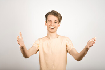 The guy stretched out his arms to greet or welcome on a white background.
