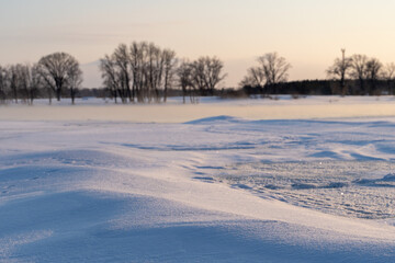 Winter sunset on the big river, hummocks in the rays of the sun.