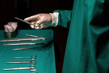 staff preparing medical instruments operating surgery in emergency room. er doctor checking metal...