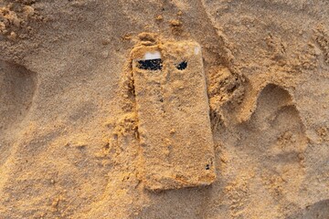 Smart phone in sand