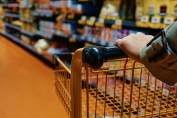 Close up of woman with shopping cart at supermarket.