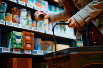 Close up of woman buying groceries in supermarket.