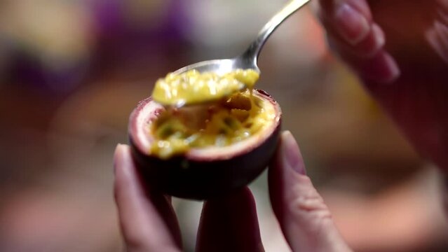 eating passion fruit with spoon. tropical fruits