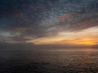 Obraz premium Sunset nature scene with ocean and dark dramatic sky. Galway bay, west coast of Ireland.