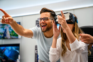 Group of people using virtual reality headset at exhibition, show. VR technology simulation concept