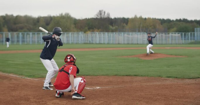 College sports, guys play baseball, the pitcher throws the ball towards the batter, school sports.